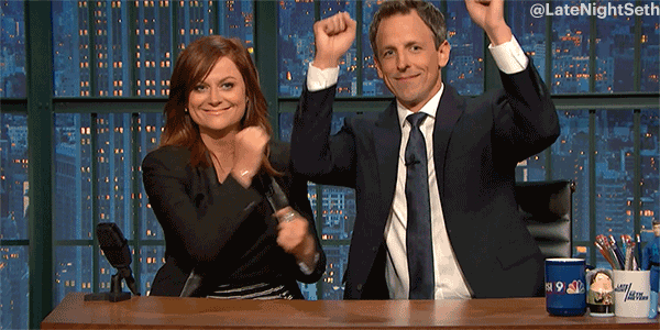 GIF of Amy Poehler and Seth Meyers dancing while sitting down