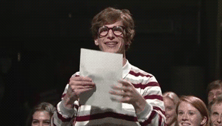 Andy Samberg shakily holding a piece of paper