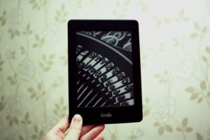 Image of a Kindle that is displaying a close-up image of the plates from an old fashioned typewriter to emphasize the importance of writing alternative text, which helps with SEO and makes content work for you.