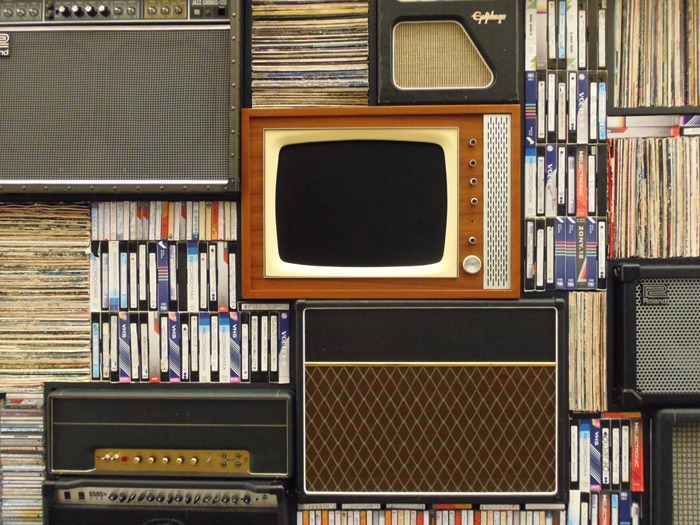 A photo image of vintage radios, amplifiers, cassette tapes, VHS tapes, and an old, antique television used to emphasize when it's time for a website redesign for a blog post at WebDevStudios.