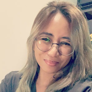 Photo of JC Palmes, a frontend engineer at WebDevStudios, where she is wearing glasses and smiling pleasantly at the camera.