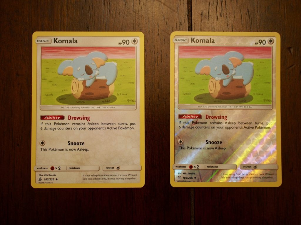 Two printings of the Komala card, one normal and the other reverse holographic.