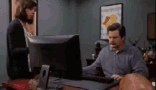 A GIF of Ron from Parks & Rec throwing his computer into a dumpster.