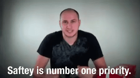This is a GIF of a man putting on sunglasses and the text on the GIF reads, "Saftey is number one priority."