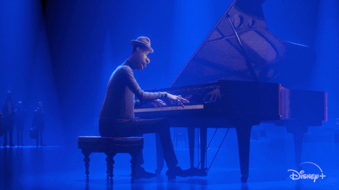 This is a GIF from the Disney and Pixar movie, Soul. The lead character is playing a black grand piano.