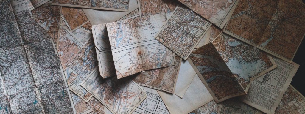 This is an downward angle photograph of a collection of maps.
