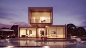 This is a low-light photograph of the exterior of a modern designed home to exemplify structure.