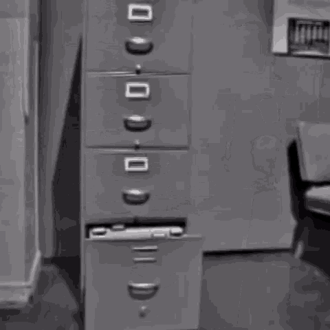 This is a black and white video GIF of a filing cabinet drawer opening and being incredibly, impossibly, comically long. 
