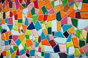 This is a photo of a mosaic wall with many colorful tiles.
