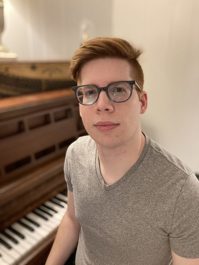 This is a photograph of Alex Maldonado, Frontend Engineer at WebDevStudios, sitting as his piano.