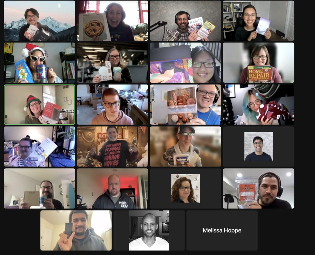This is a screenshot of some of the WebDevStudios team members on a Zoom online meeting. Most of them are holding up their Secret Santa gift.