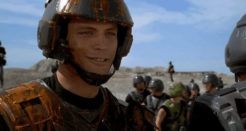 This is a GIF of a character from the movie Starship Troopers, covered in goo, saying, "Thank you, sir."
