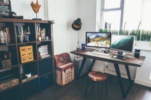 This is a photo of an in-home office with a computer on a desk.