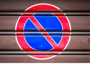 This is an image of the ban icon painted on a metal wall.