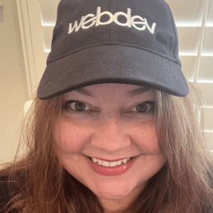 This is a portrait of Jen Miller, Director of Accounts, wearing a WebDevStudios cap.