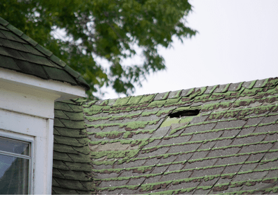 This is a photo of damage to a house roof.